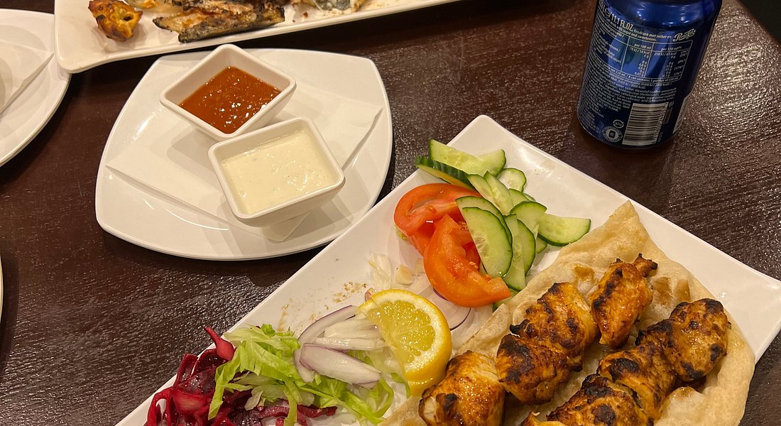 Chicken skewers with salad and sauces