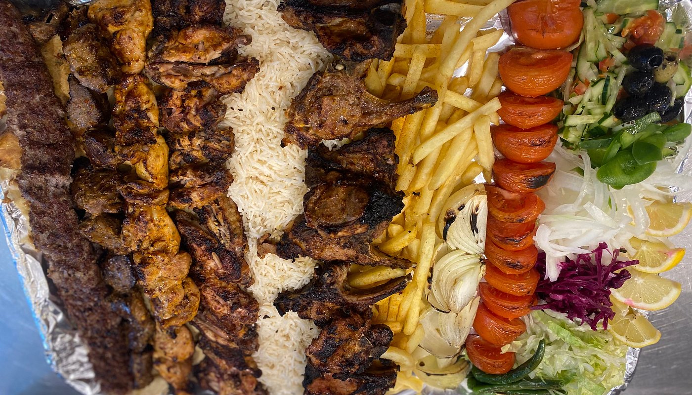 Large mixed grill platter with rice, chips and salad